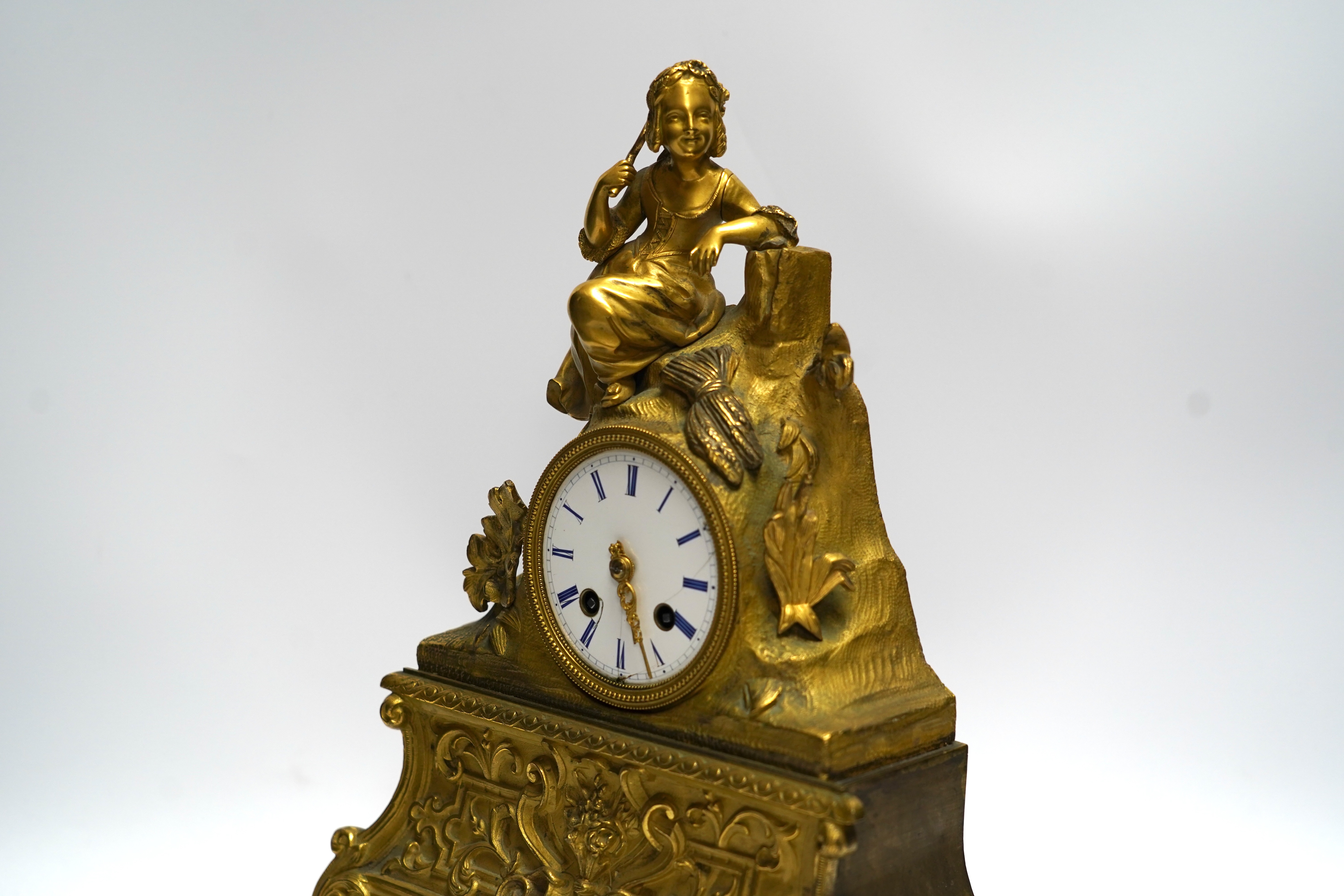 A mid 19th century French ormolu figural mounted clock with silk suspension, with key, 36cm